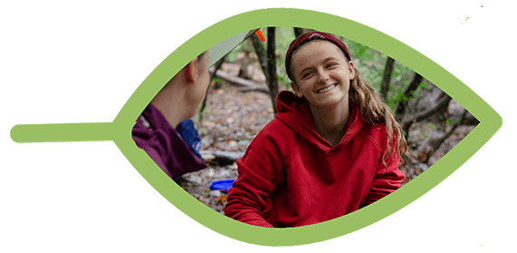 teen girl smiling at a campsite