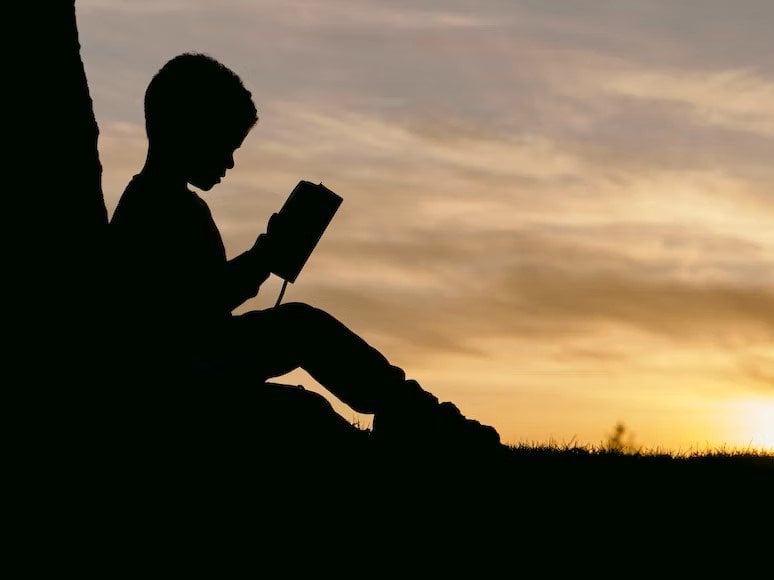 middle school boy reading a boy