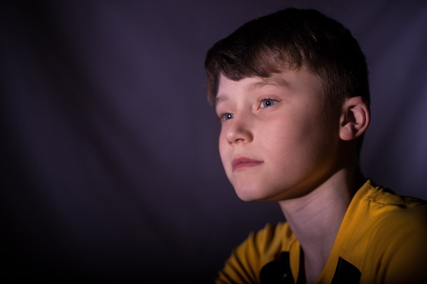 Young boy in yellow shirt overcoming teen bullying.