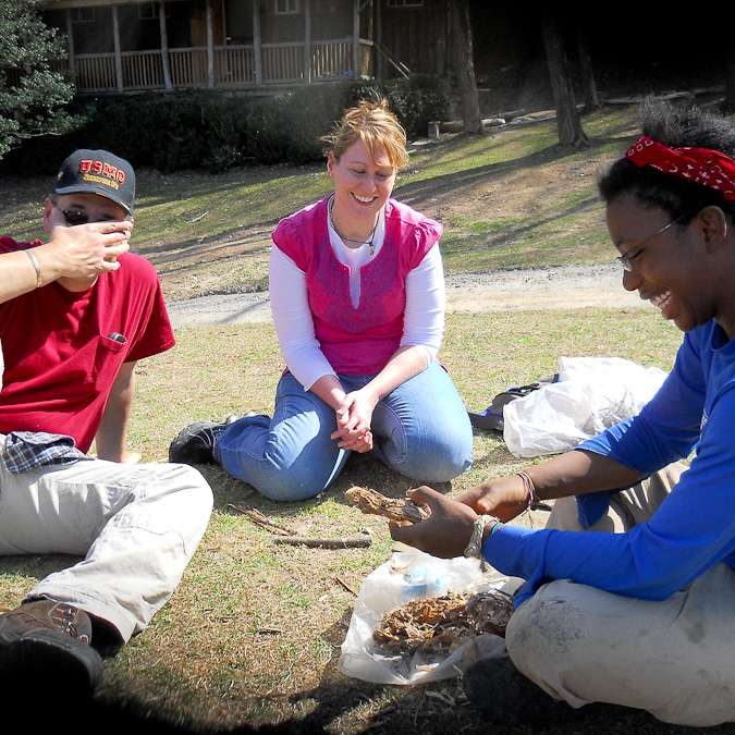 Adoptive family sits in a circle outside and engages in therapeutic activity. The impact of family involvement on at-risk youth.